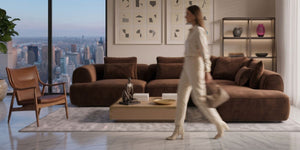 Modern living room with a cityscape view, brown sofa, and wooden armchair.