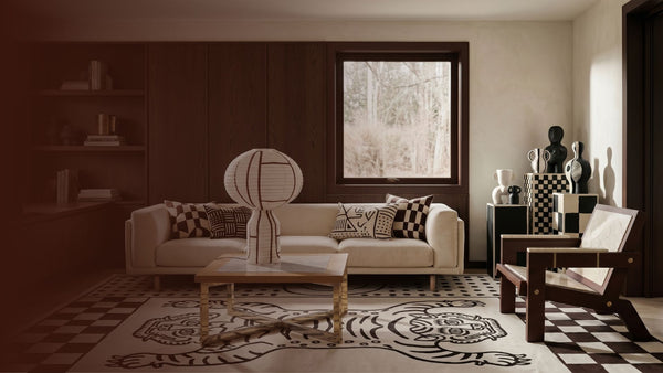 Living room with a white sofa, coffee table, and decorative items.
