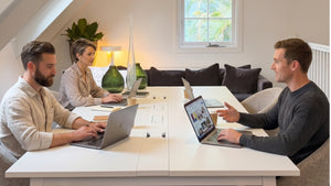 Interior design team reviewing trend research, furniture concepts and brand strategy during a studio planning meeting.