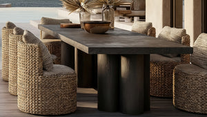 Dining table with woven chairs in an outdoor setting